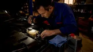 Mechanic checking brake fluid in car engine