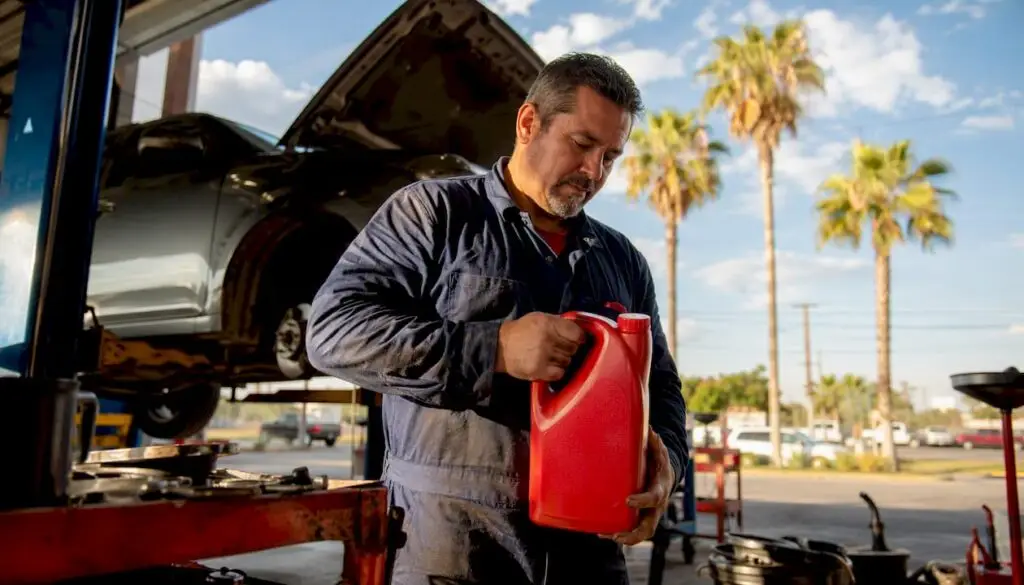 Mechanic holding synthetic oil in Texas auto shop