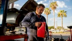 Mechanic holding synthetic oil in Texas auto shop