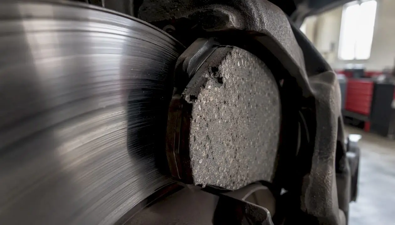 Close-up ceramic brake pad and rotor detail
