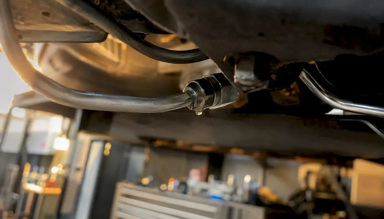 Close-up brake line with fluid leak droplet