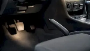 Close-up of car hand lever and foot pedal e brakes