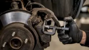 Mechanic inspecting brake caliper and rotor