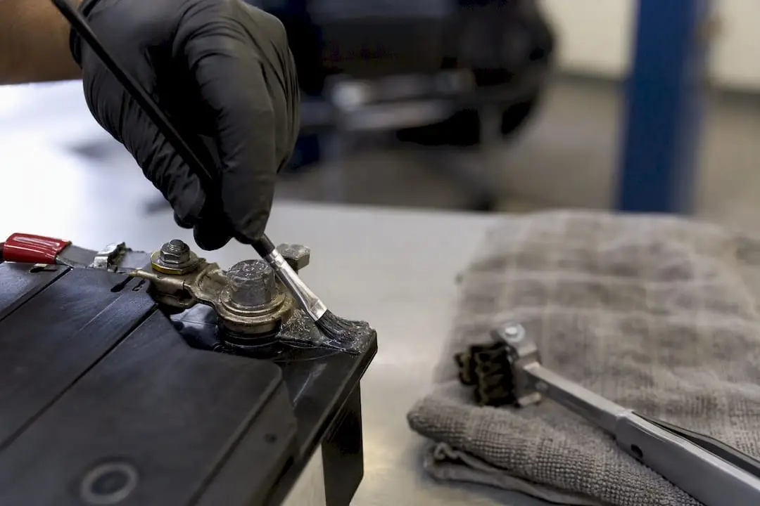 Applying petroleum jelly on battery terminals