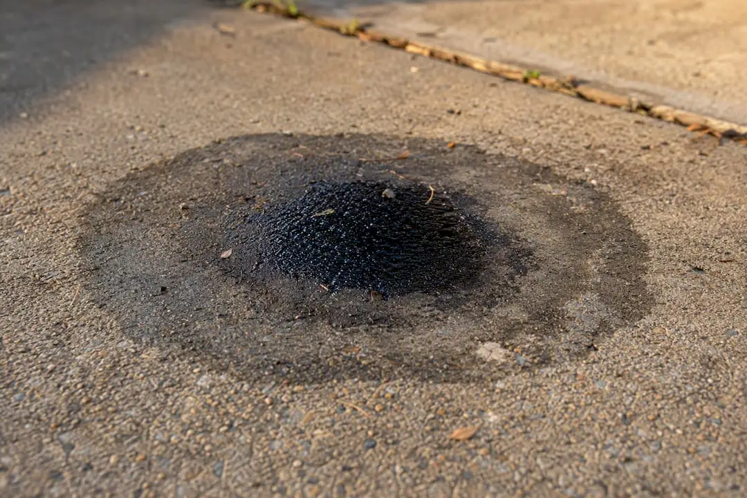 Close-up oil puddle and stains on driveway