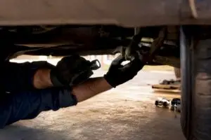 Technician inspecting fleet vehicle suspension