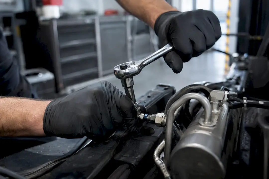 Hands tightening bolt on brake assembly