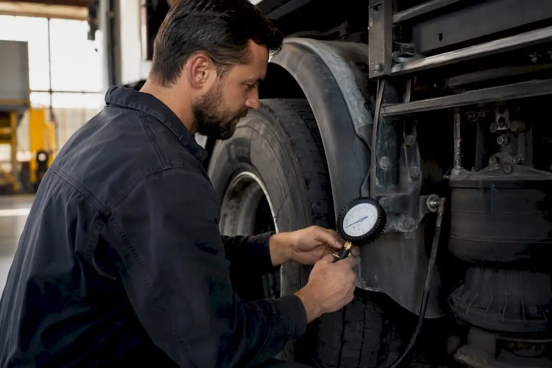 Technician testing commercial vehicle inspection components