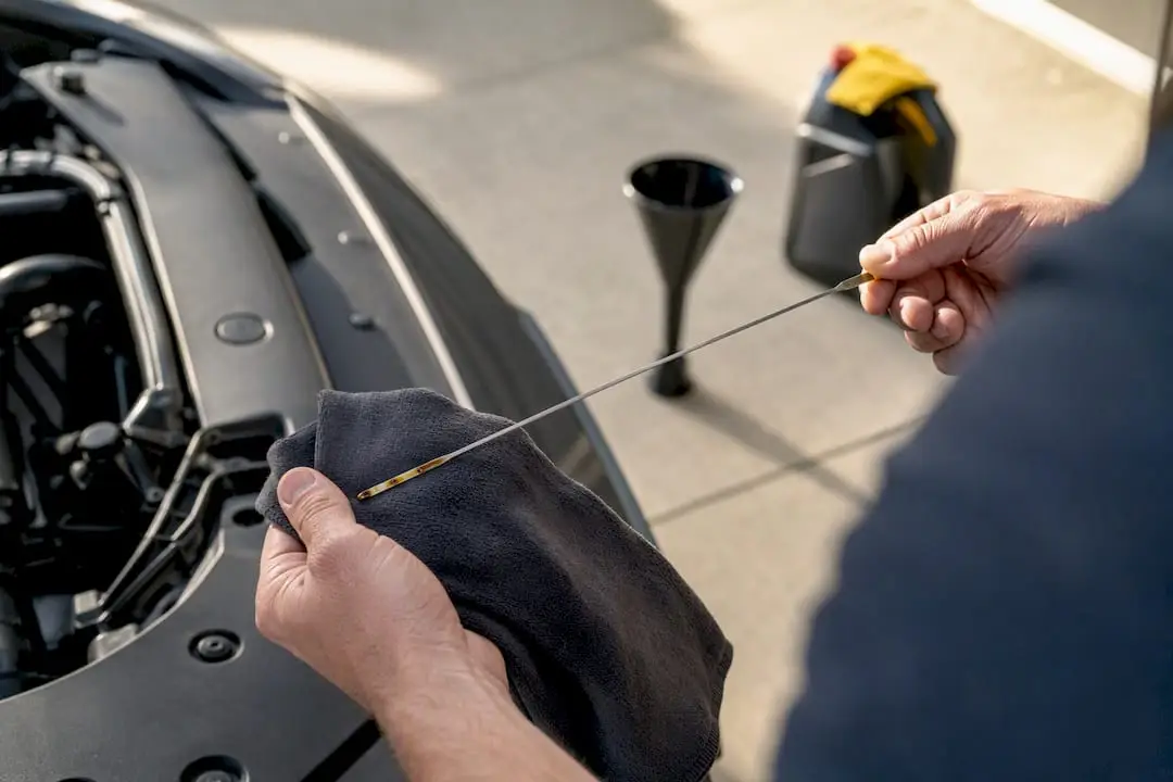 Owner checking engine oil dipstick