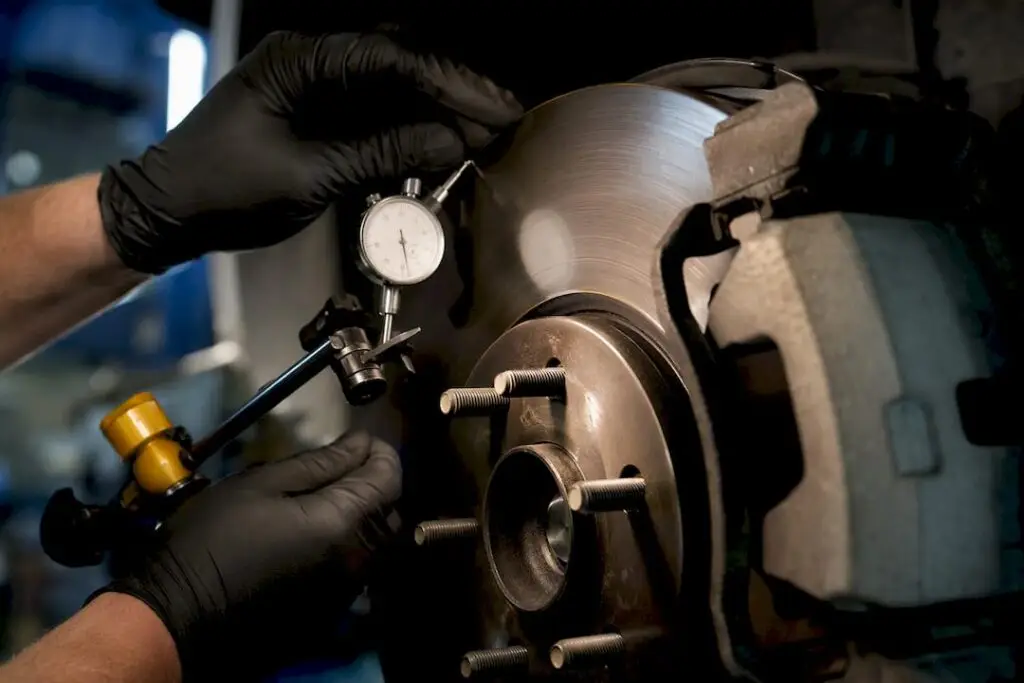 Technician measuring brake rotor runout