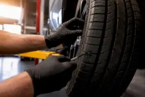 Technician inspecting a tire puncture