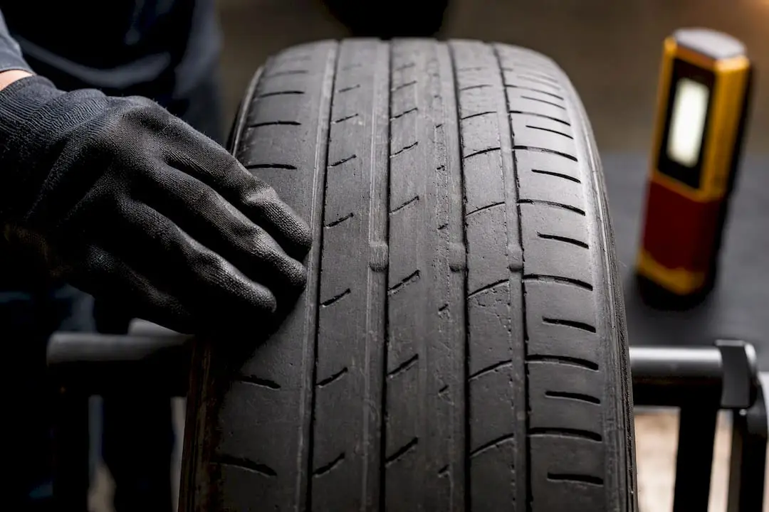 Technician feeling uneven tire tread