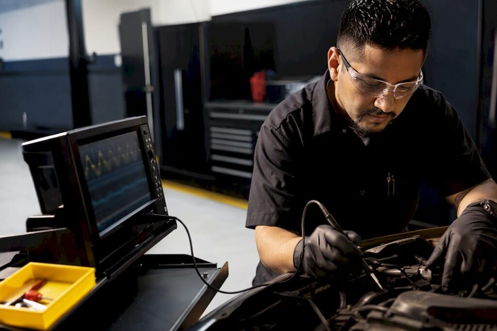 Technician diagnosing engine misfire waveform