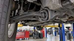 Control arm bushing beneath a sedan