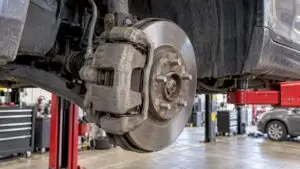 Brake caliper and rotor on raised sedan